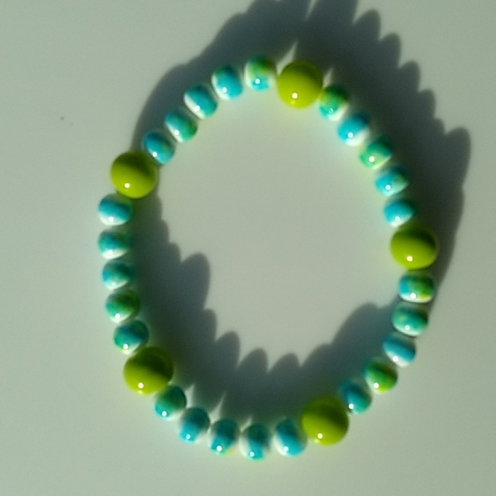 Lime green beads with a teal,white and yellow stretch bracelet